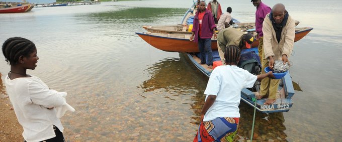 Women traders buy fish from fishermen to trade at Ngwenye market in Mpulungu, Zambia