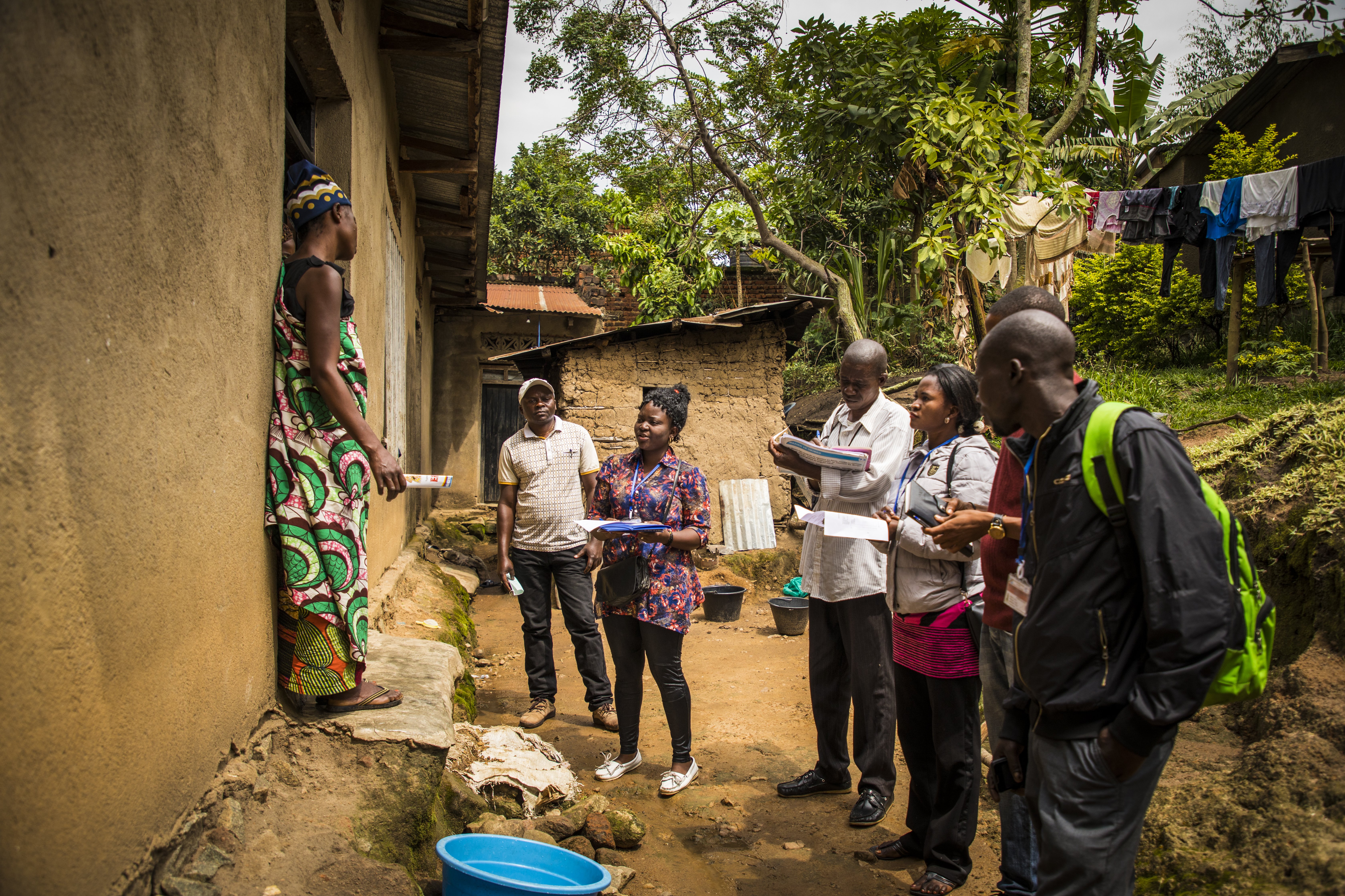 Community representatives visit a family on the outskirts of Beni, DRC to raise awareness about Ebola