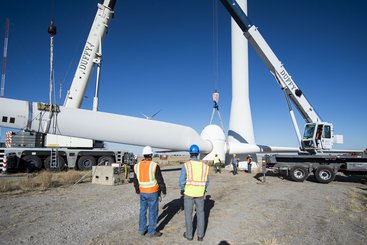 NREL engineers and technicians lower the rotor and blades off of the Cart 3 research turbine at NREL's National Wind Technology Center.