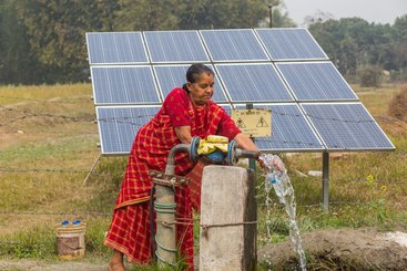 A farmer with her solar irrigation pump in Nepal Balahar Daha Village, Saptkoshi Minicipality, Saptari District of Nepal.
