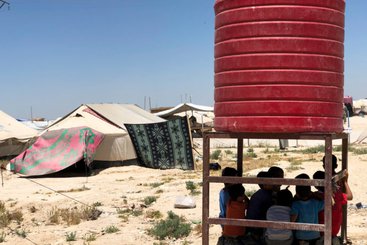 North East Syria, Al Hassakeh Governorate, Al Hol camp for internally displaced persons. Children in the shadow of a water tank.