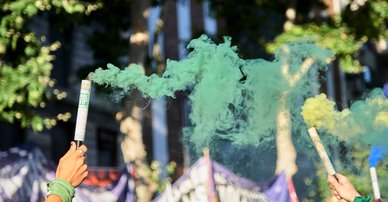 Women raising symbolic green smoke bombs take part in a rally at the National Congress, defending their legal right to safe and free abortion in Buenos Aires, Argentina, December 2020.