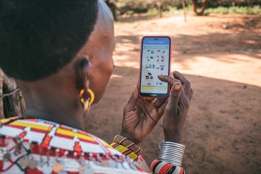 Samburu woman, North Kenya, enters data into the Mbiotisho app