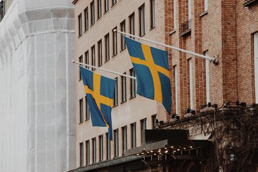 Two Swedish flags hanging off a building. 2020.
