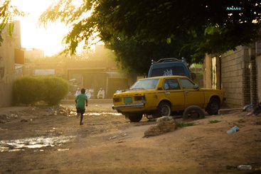 A child runs down a road while playing in Khartoum, Sudan (2022)