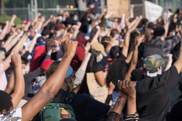 Protestors raise their hands in solidarity outside of the Fifth Police Precinct in Minneapolis in response to the death of George Floyd.
